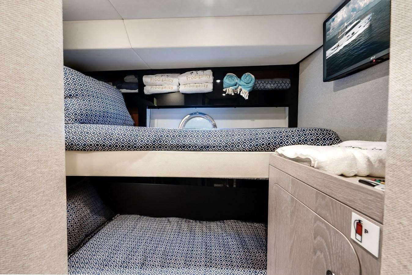 a room with a bed and tv aboard PRODIGALITY 4 Yacht for Sale