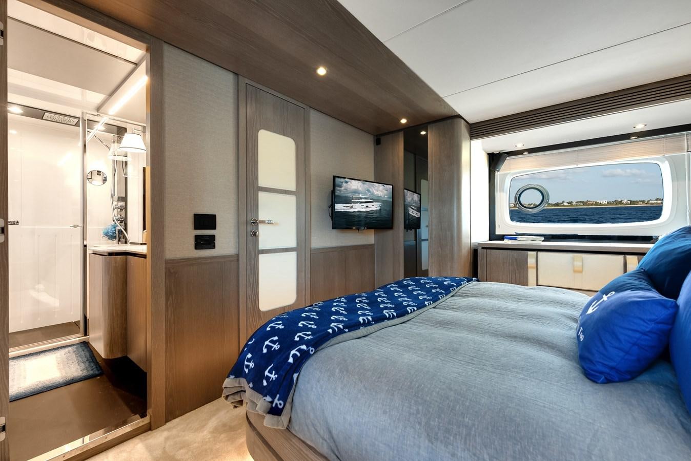 a bedroom with a bed and a television aboard PRODIGALITY 4 Yacht for Sale