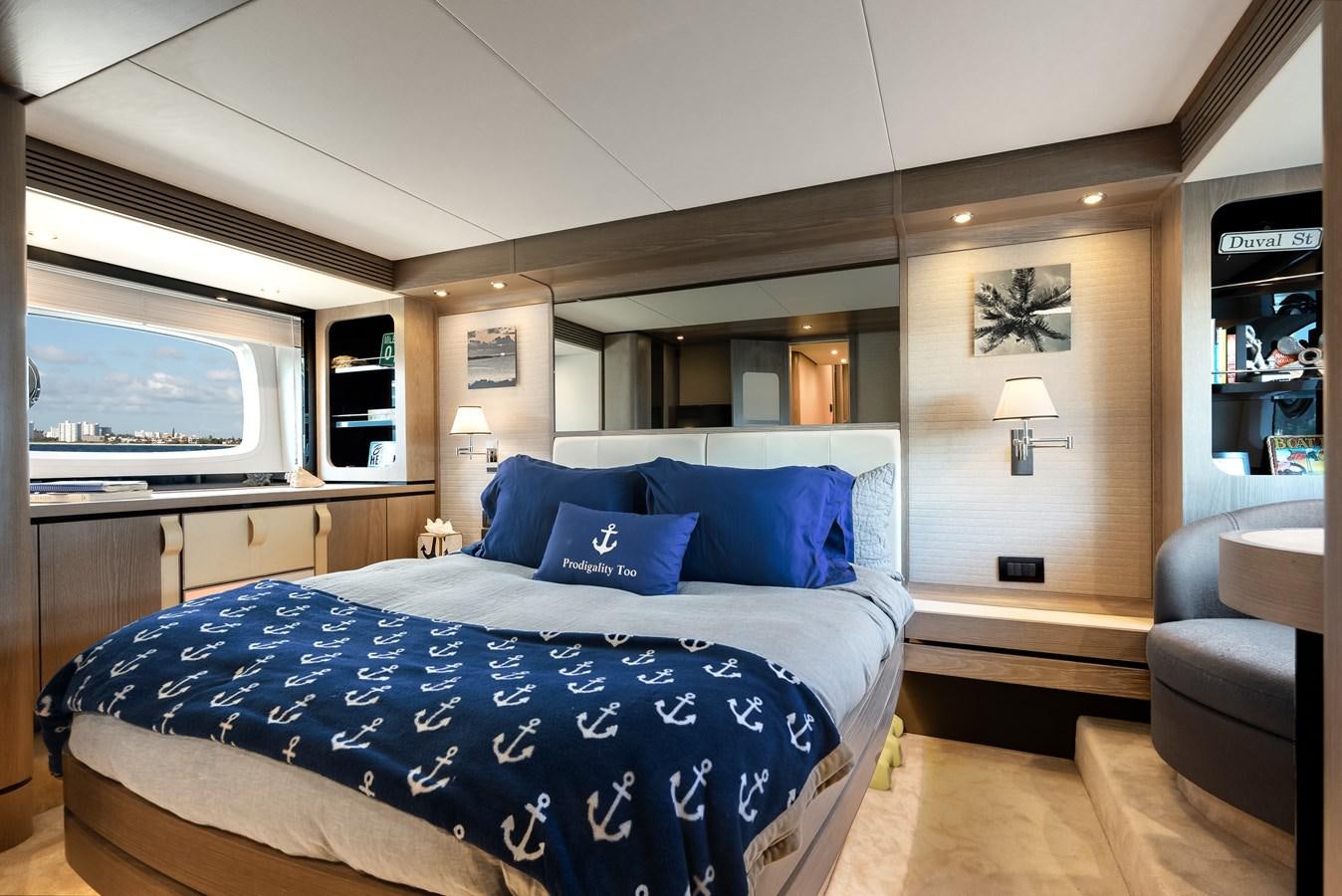 a bedroom with a blue bed aboard PRODIGALITY 4 Yacht for Sale