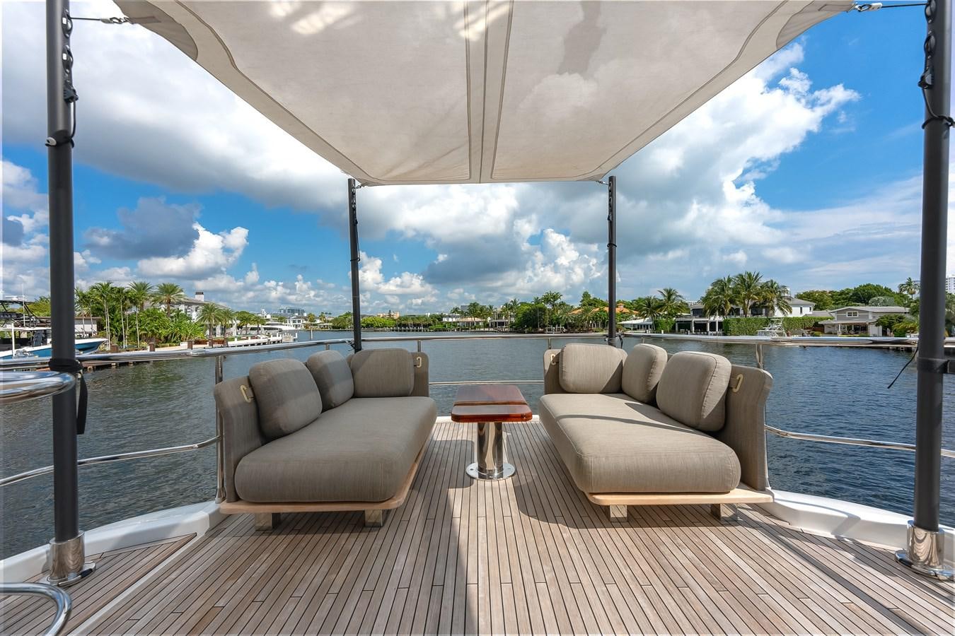a deck with chairs and a body of water aboard PRODIGALITY 4 Yacht for Sale