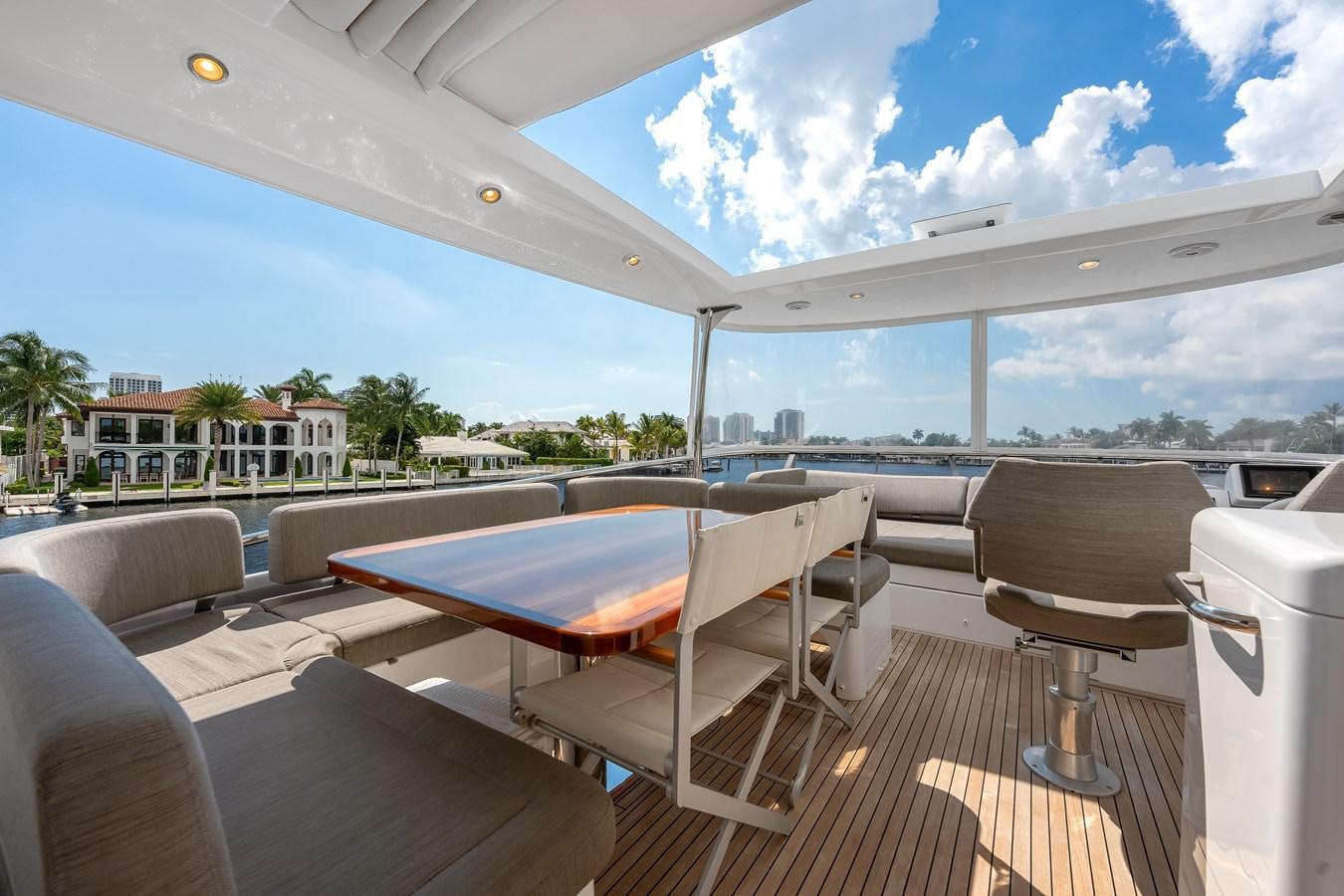 a deck with a table and chairs aboard PRODIGALITY 4 Yacht for Sale