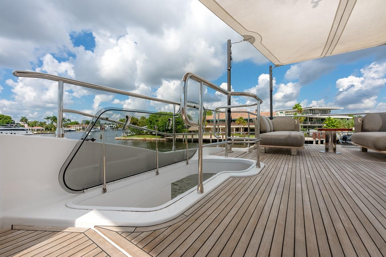 a deck with a large pool aboard PRODIGALITY 4 Yacht for Sale