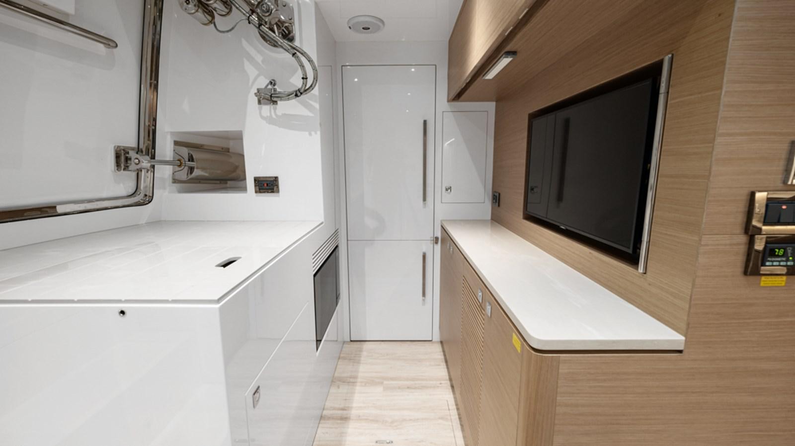 a room with a tv and cabinets aboard 90 HORIZON Yacht for Sale