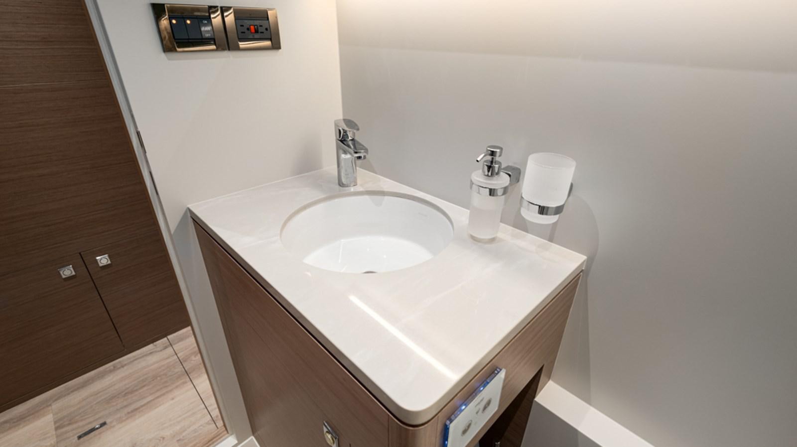 a bathroom with a sink and a mirror aboard 90 HORIZON Yacht for Sale