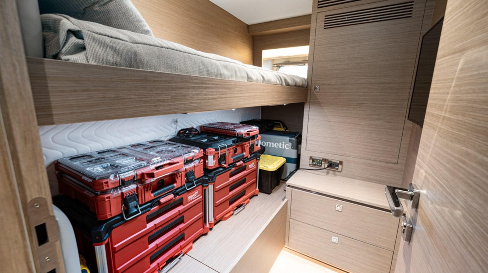 a room with a bed and a desk aboard 90 HORIZON Yacht for Sale