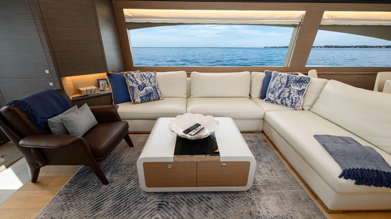 a living room with a couch and a table aboard 90 HORIZON Yacht for Sale