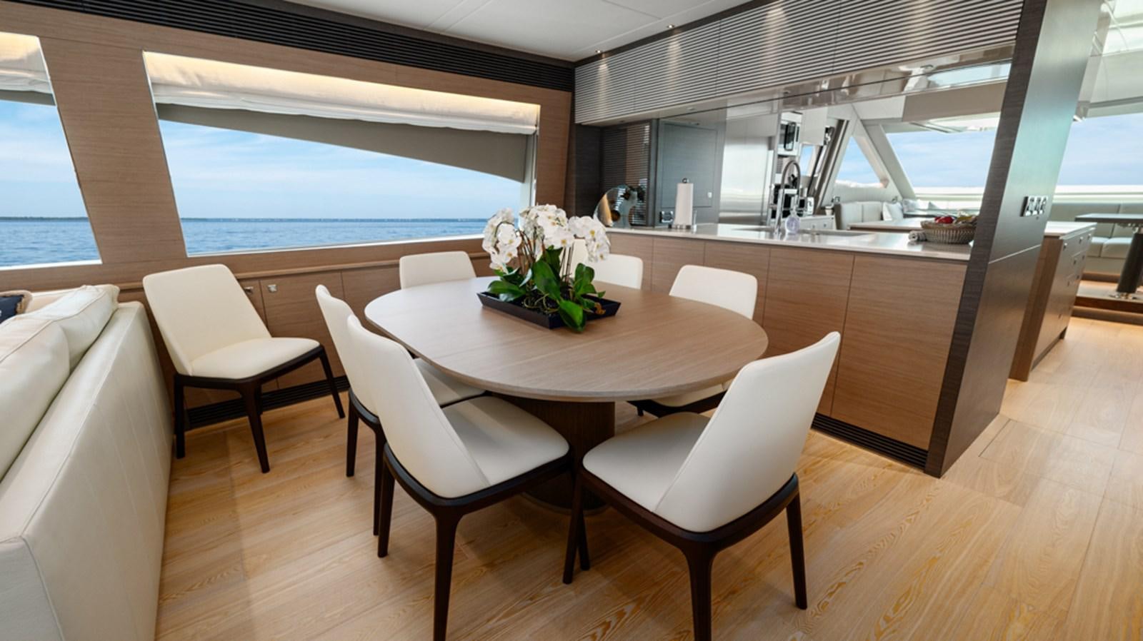 a kitchen with a table and chairs aboard 90 HORIZON Yacht for Sale