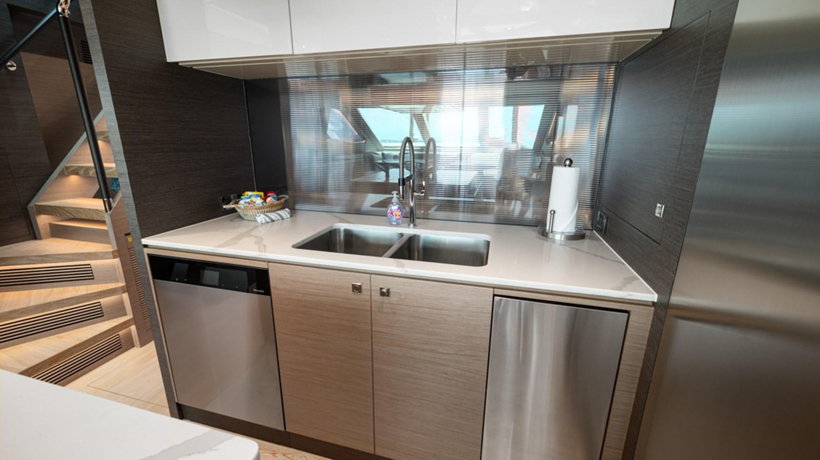a kitchen with a sink and a large mirror aboard 90 HORIZON Yacht for Sale
