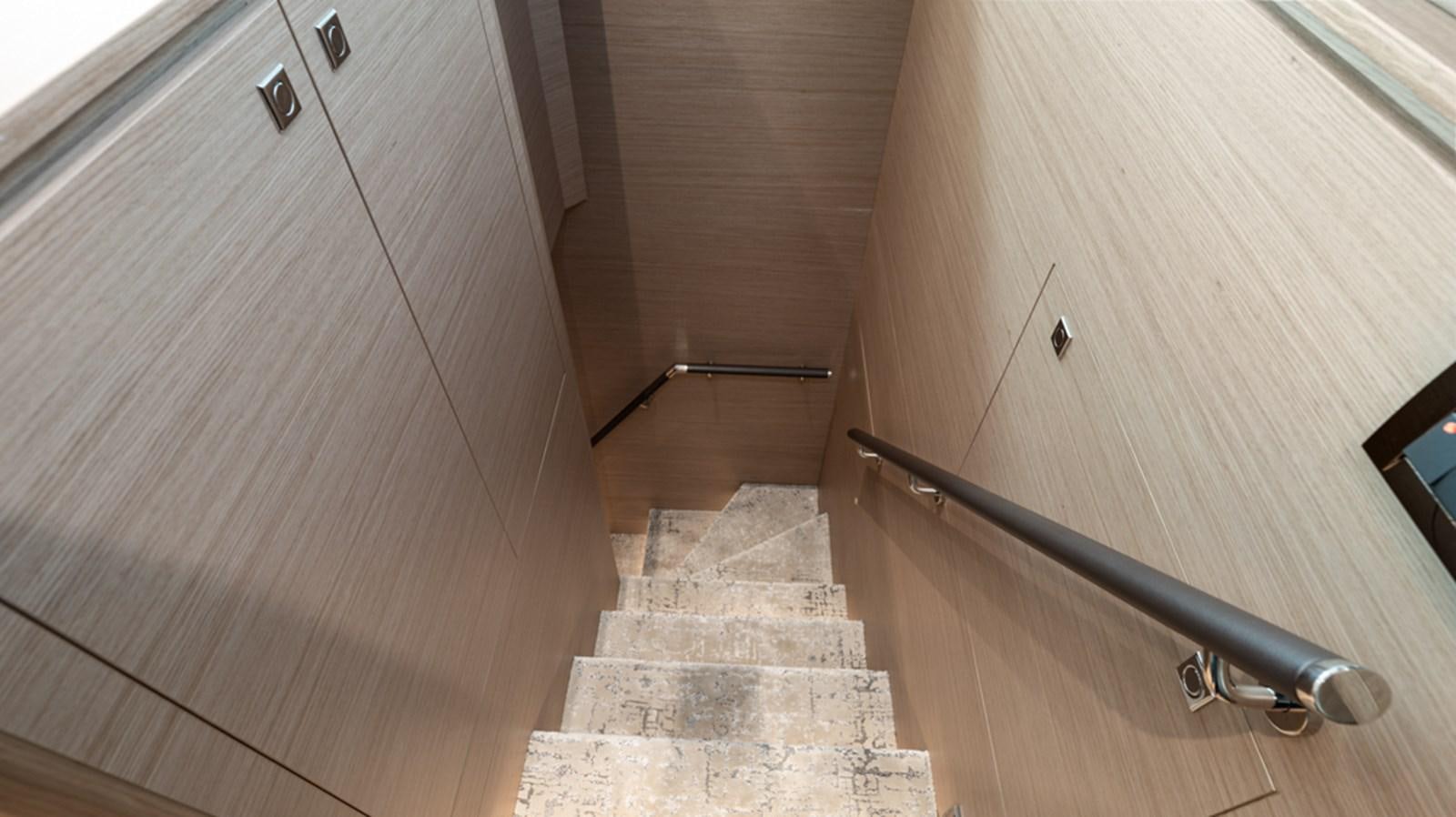 a wooden staircase with a metal railing aboard 90 HORIZON Yacht for Sale