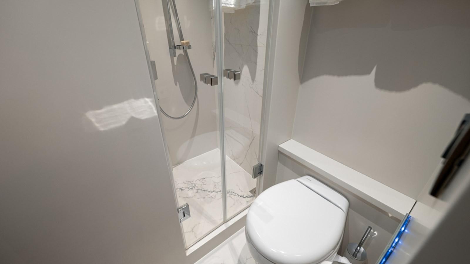 a bathroom with a shower and toilet aboard 90 HORIZON Yacht for Sale