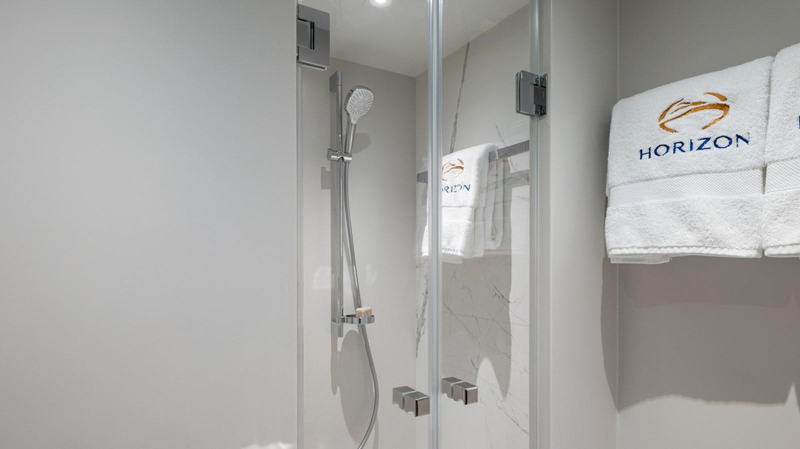 a shower unit with a towel on the wall aboard 90 HORIZON Yacht for Sale
