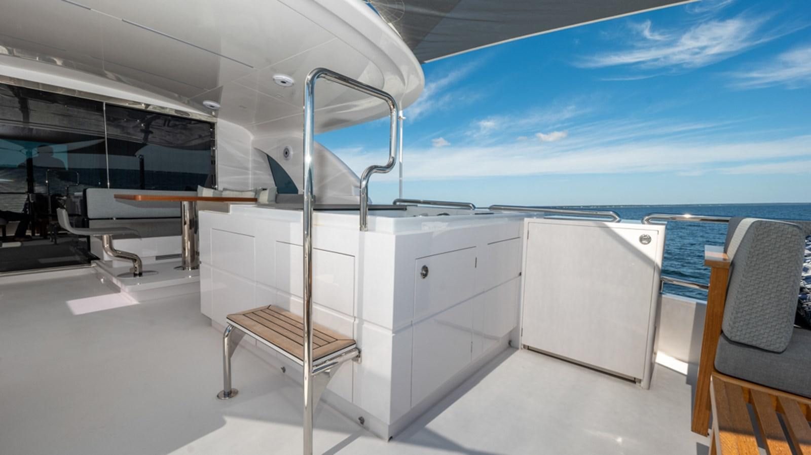 a white room with a chair and a table and chairs aboard 90 HORIZON Yacht for Sale