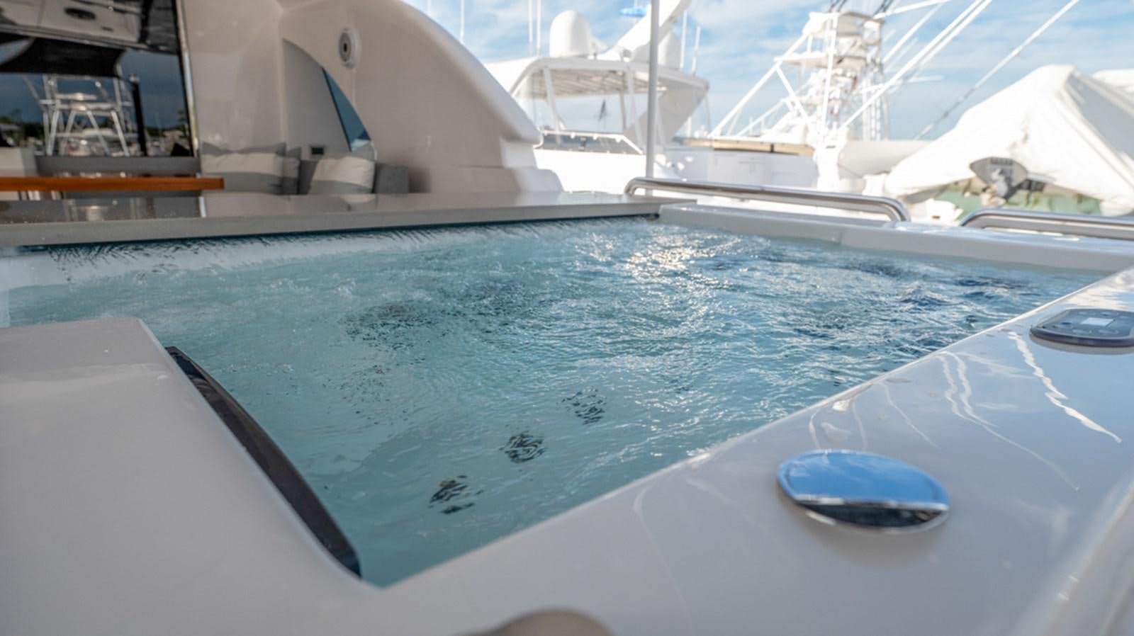 a pool with a boat in the background aboard 90 HORIZON Yacht for Sale
