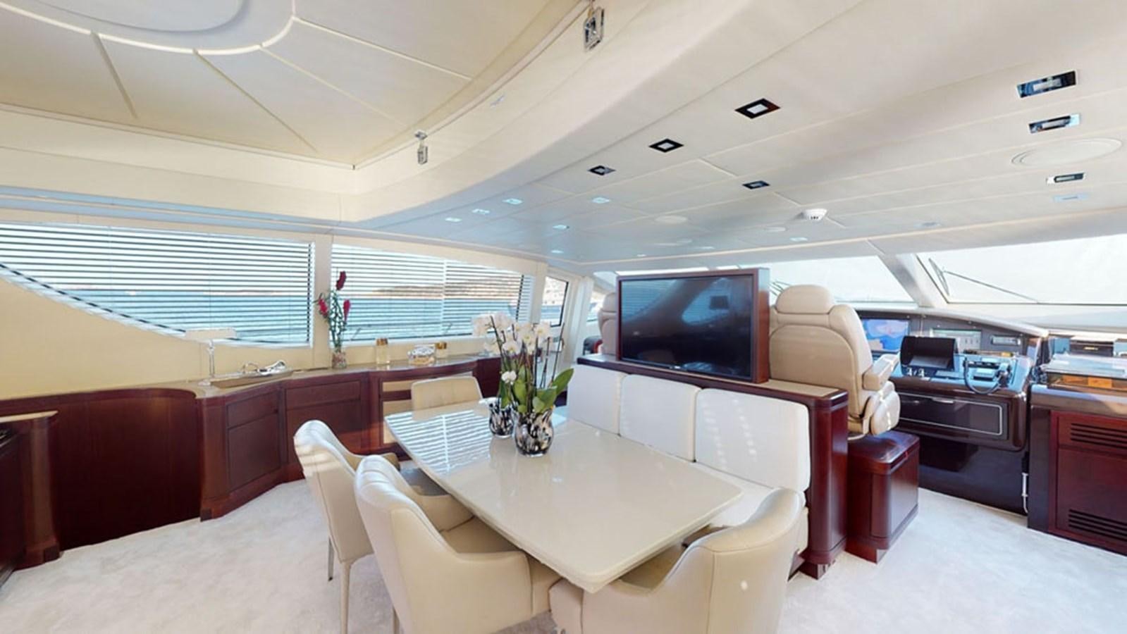 a room with a table and chairs aboard PAULA & BIEL Yacht for Sale
