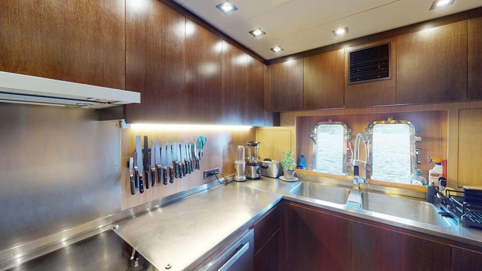 a kitchen with wooden cabinets aboard PAULA & BIEL Yacht for Sale