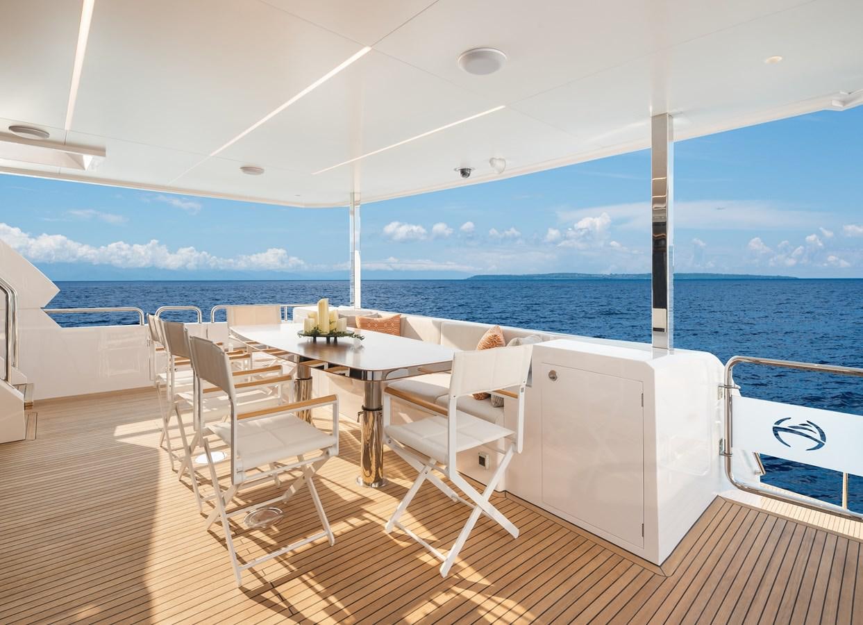 a room with a table and chairs aboard HORIZON FD80-614 / NOW AVAILABLE  Yacht for Sale