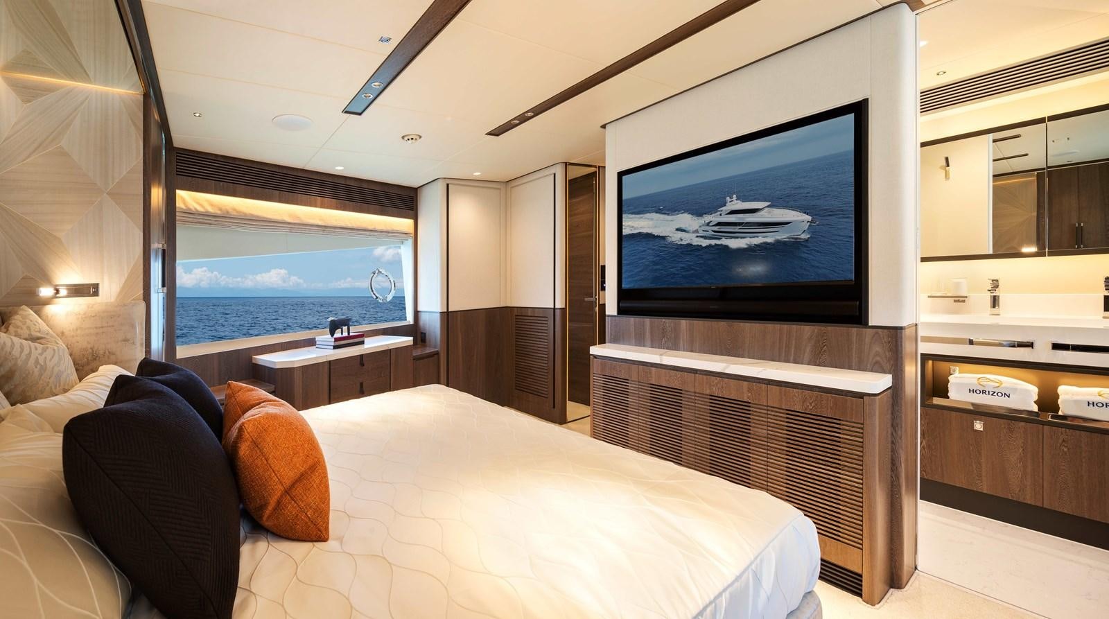 a bedroom with a large flat screen television and a bed aboard HORIZON FD80-614 / NOW AVAILABLE  Yacht for Sale