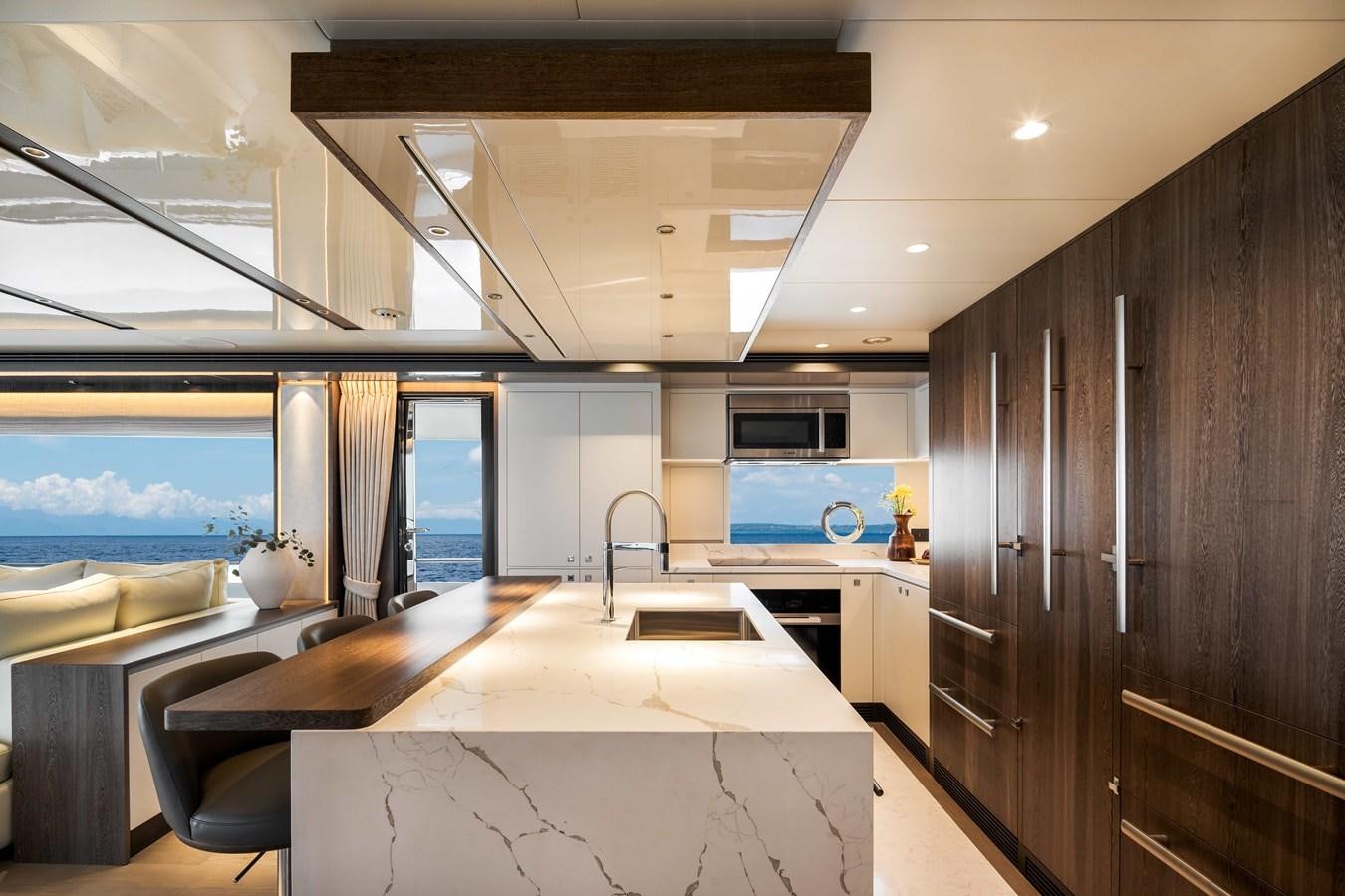 a kitchen with a large island aboard HORIZON FD80-614 / NOW AVAILABLE  Yacht for Sale