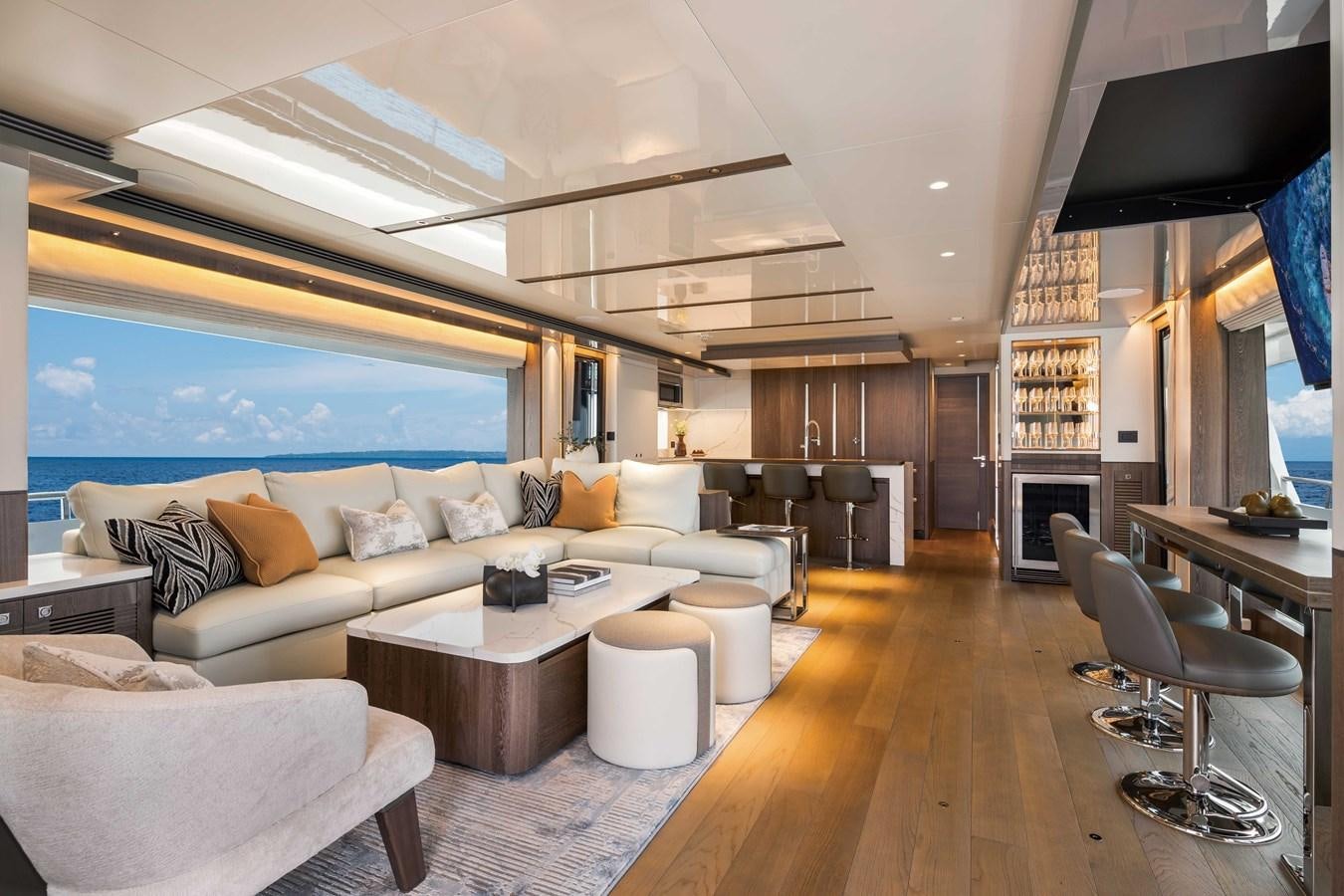 a living room with a large screen aboard HORIZON FD80-614 / NOW AVAILABLE  Yacht for Sale