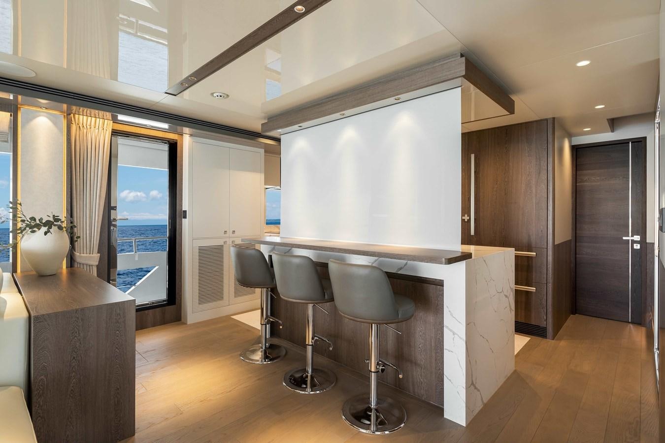 a room with a table and chairs aboard HORIZON FD80-614 / NOW AVAILABLE  Yacht for Sale