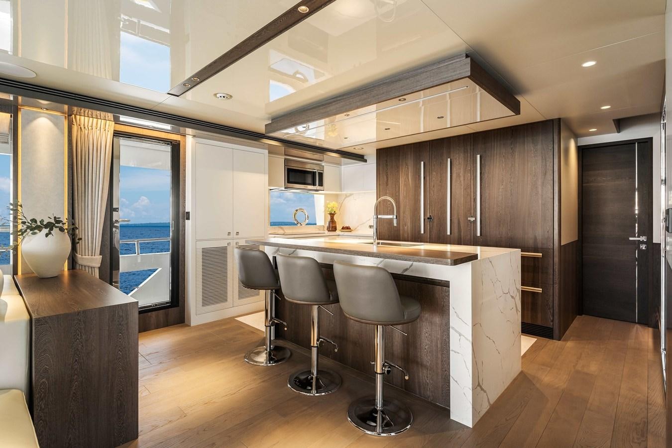 a kitchen with a bar and stools aboard HORIZON FD80-614 / NOW AVAILABLE  Yacht for Sale