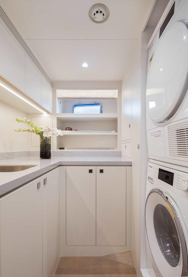 a white kitchen with white cabinets aboard HORIZON FD80-614 / NOW AVAILABLE  Yacht for Sale