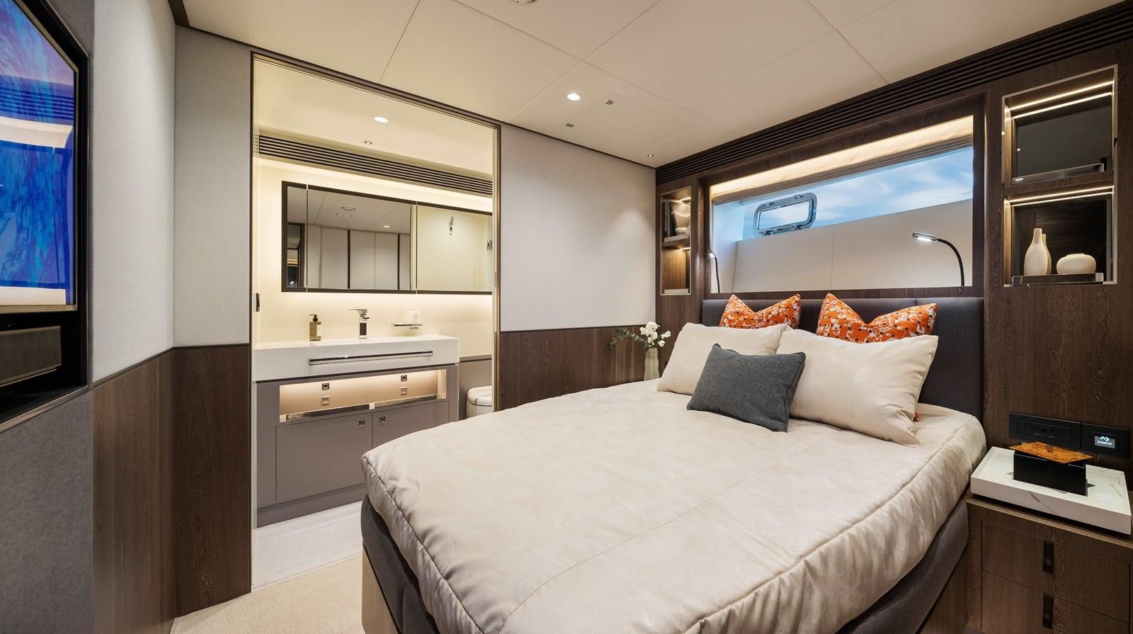 a bedroom with a bed and a mirror aboard HORIZON FD80-614 / NOW AVAILABLE  Yacht for Sale