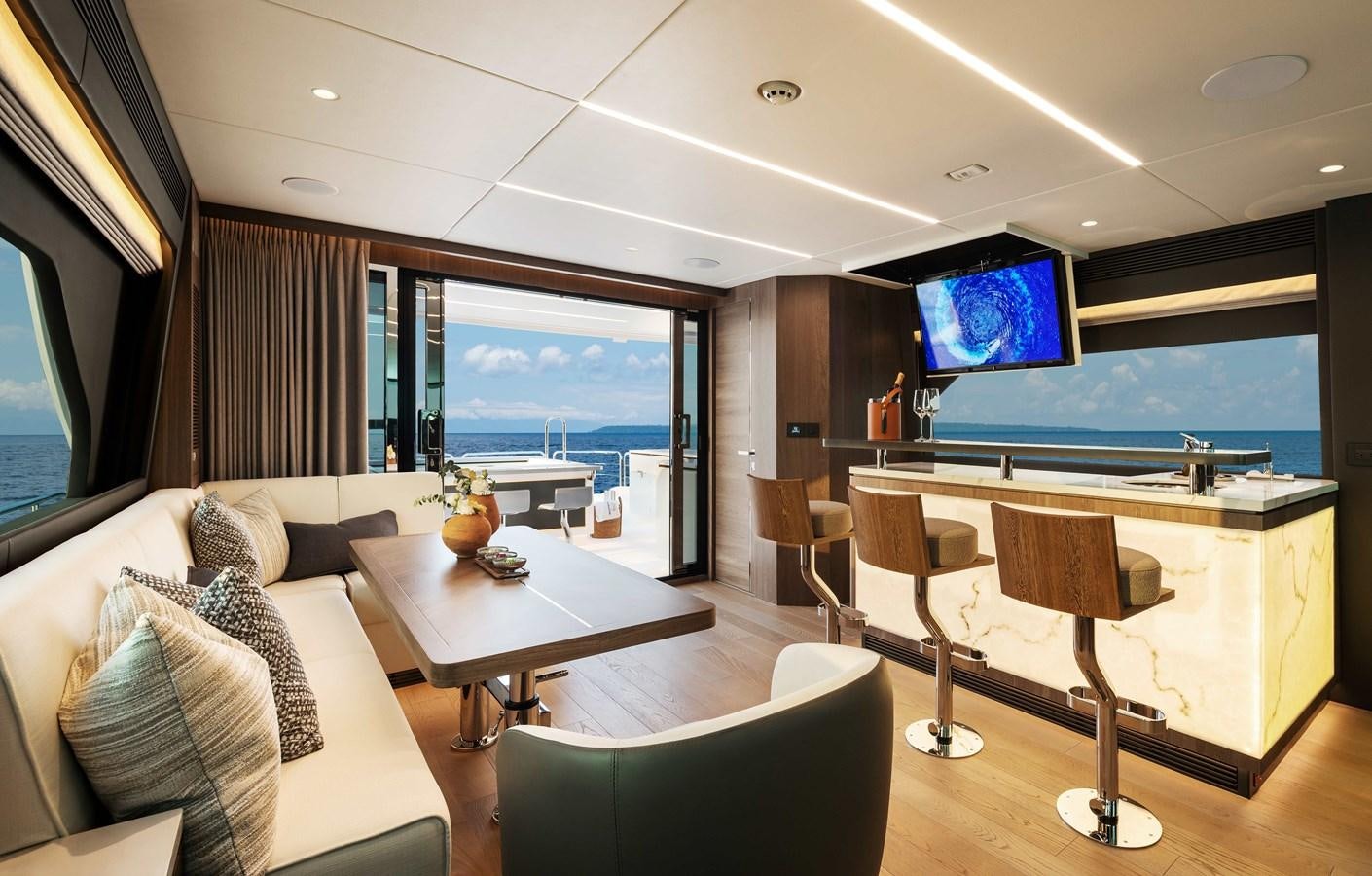 a room with a table and chairs aboard HORIZON FD80-614 / NOW AVAILABLE  Yacht for Sale