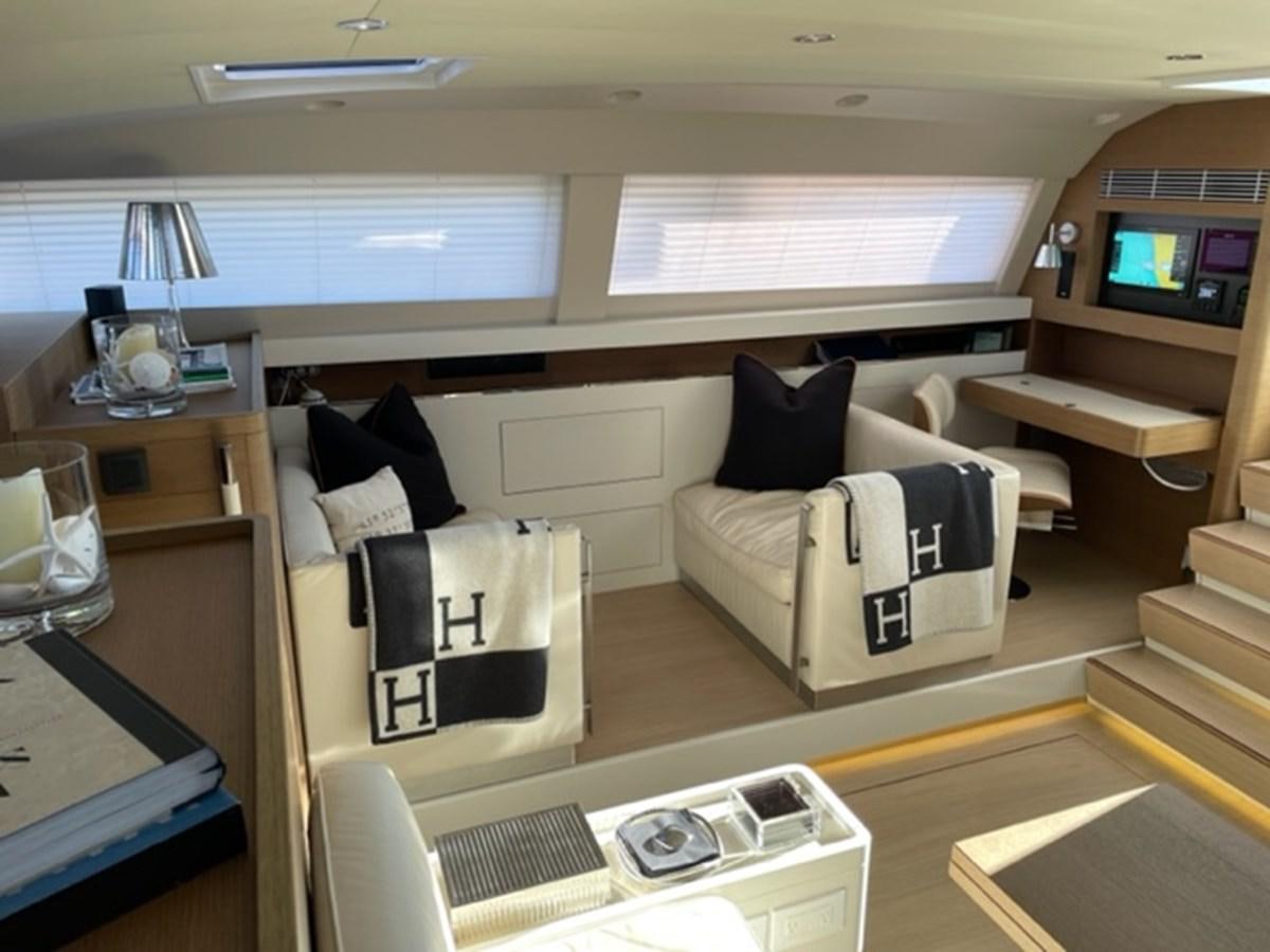 a room with a couch and a television aboard TROIS VIGNES Yacht for Sale