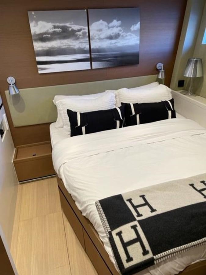 a bed with white sheets aboard TROIS VIGNES Yacht for Sale