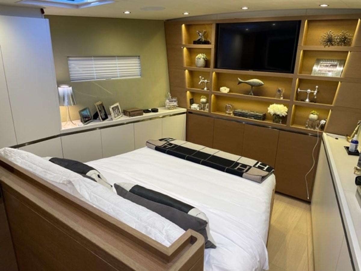 a bedroom with a bed and cabinets aboard TROIS VIGNES Yacht for Sale