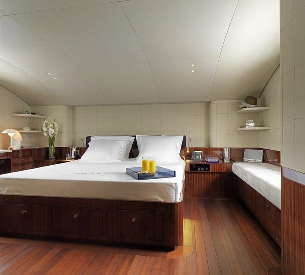 a room with a bed and a couch aboard LADY IN BLUE Yacht for Sale