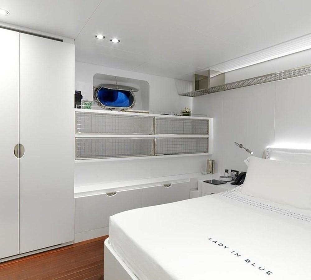 a white bedroom with a blue bowl on the wall aboard LADY IN BLUE Yacht for Sale
