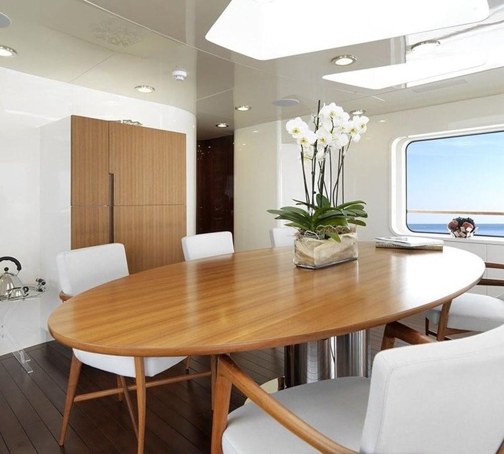 a table with chairs and a vase of flowers on it aboard LADY IN BLUE Yacht for Sale