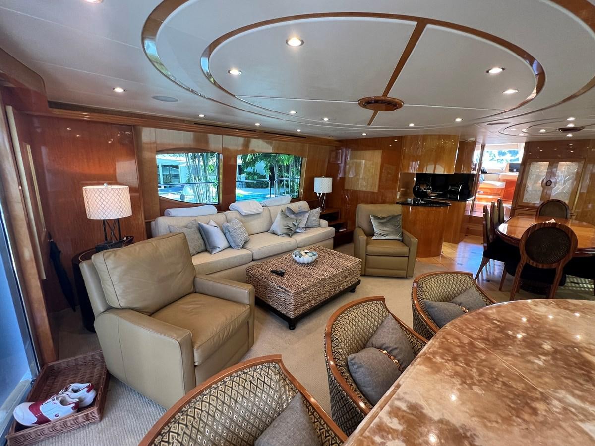 a living room with a large chandelier aboard ARETECTE Yacht for Sale