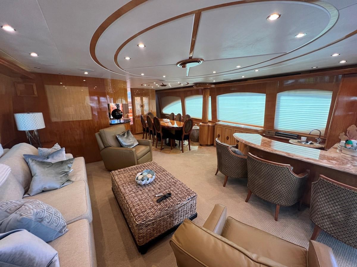 a living room with a large dining table and chairs aboard ARETECTE Yacht for Sale