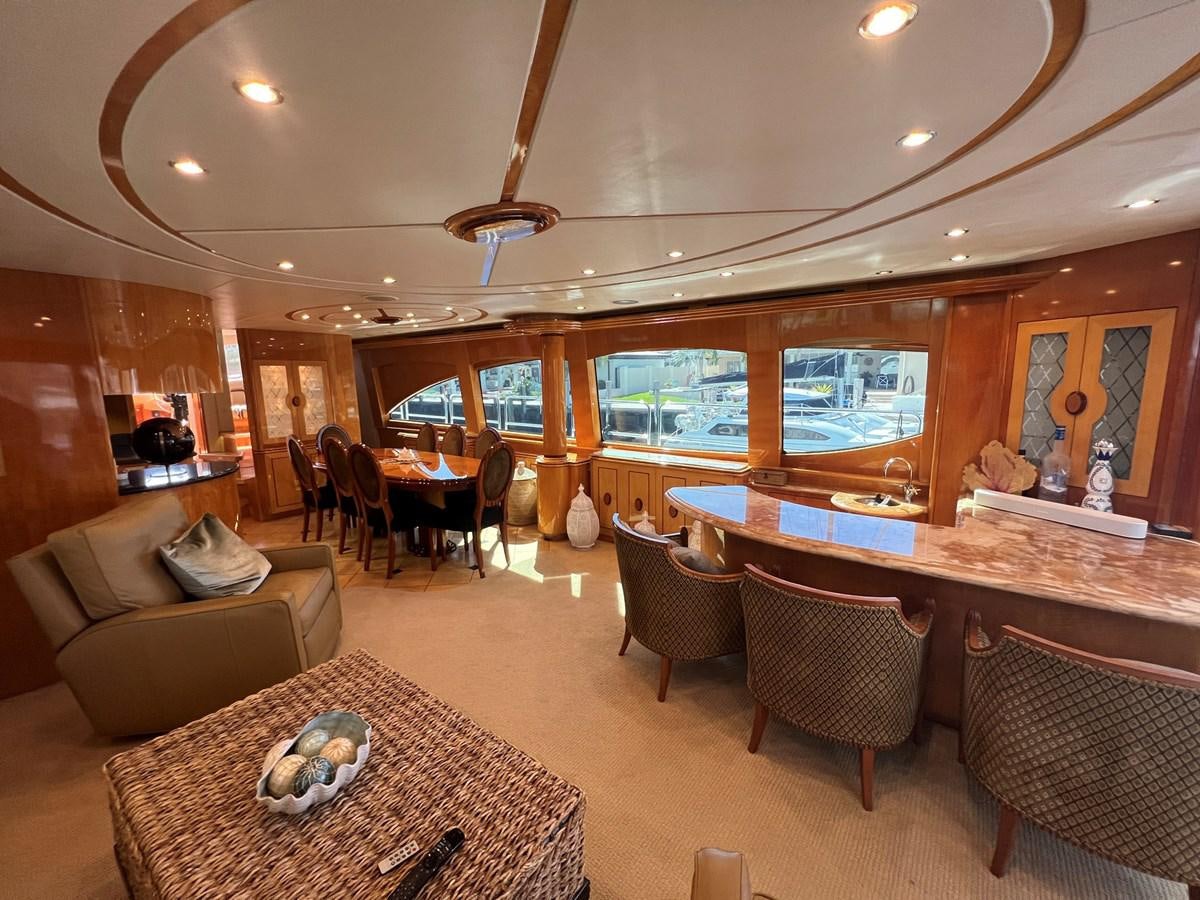 a living room with a large table and chairs aboard ARETECTE Yacht for Sale