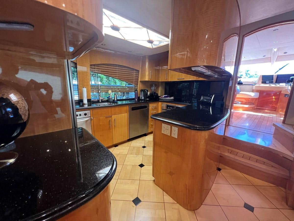 a kitchen with a black stove aboard ARETECTE Yacht for Sale