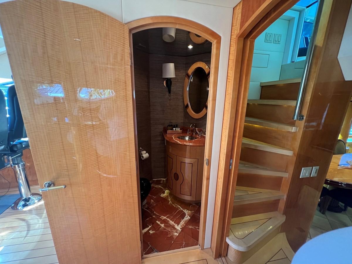 a bathroom with a wood door aboard ARETECTE Yacht for Sale