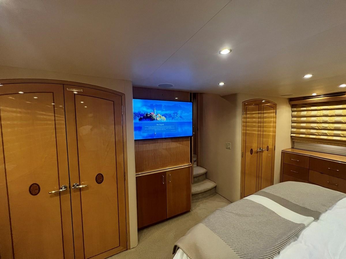 a bedroom with a large tv aboard ARETECTE Yacht for Sale