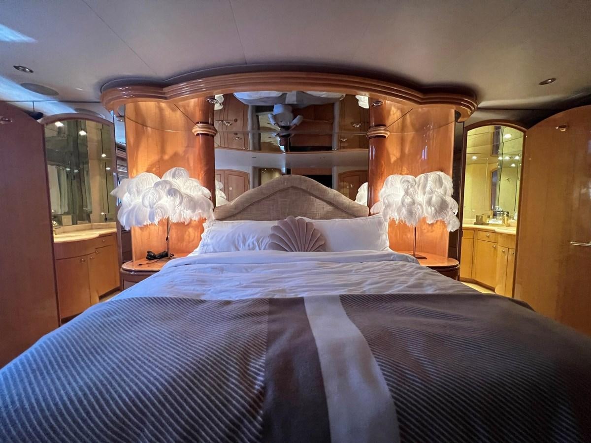 a bed with a white blanket aboard ARETECTE Yacht for Sale
