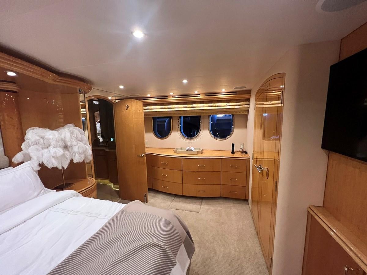 a bedroom with a bed and a television aboard ARETECTE Yacht for Sale