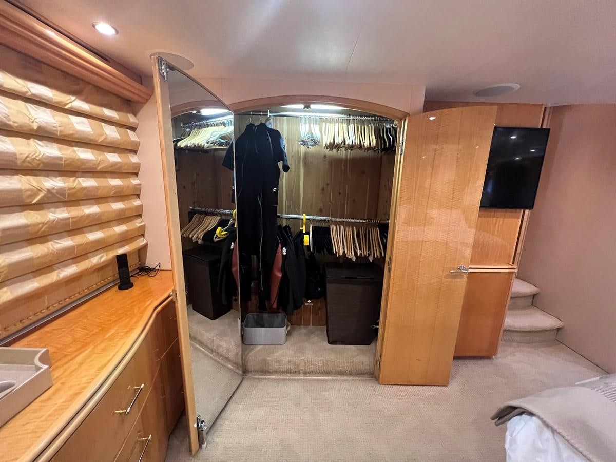 a bathroom with a closet and a mirror aboard ARETECTE Yacht for Sale