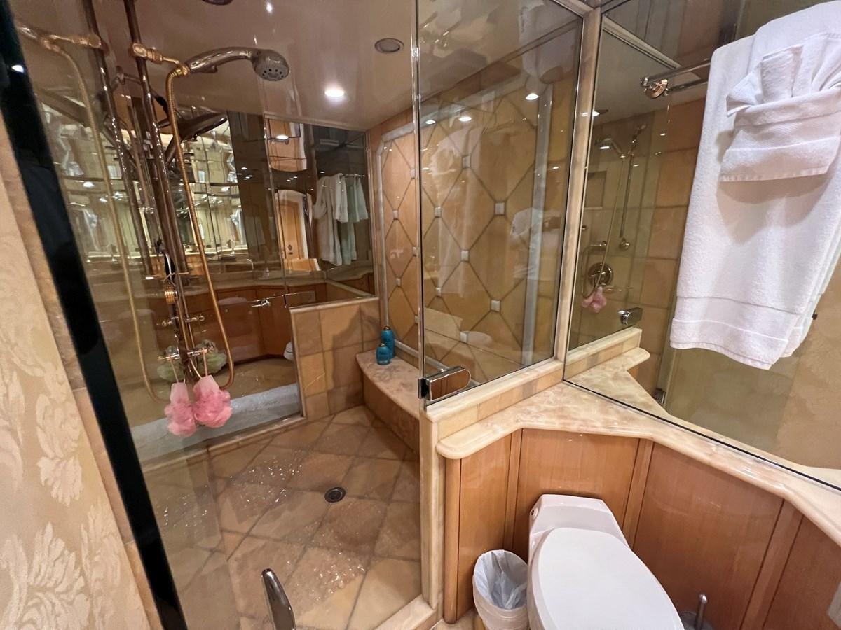 a bathroom with a glass shower aboard ARETECTE Yacht for Sale