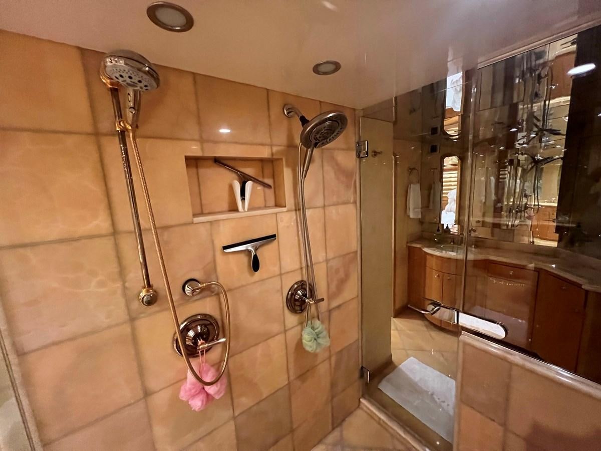 a bathroom with a glass shower aboard ARETECTE Yacht for Sale