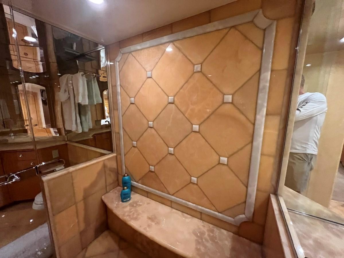 a bathroom with a glass shower aboard ARETECTE Yacht for Sale