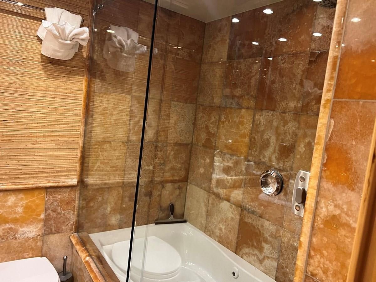 a bathroom with a shower and a toilet aboard ARETECTE Yacht for Sale