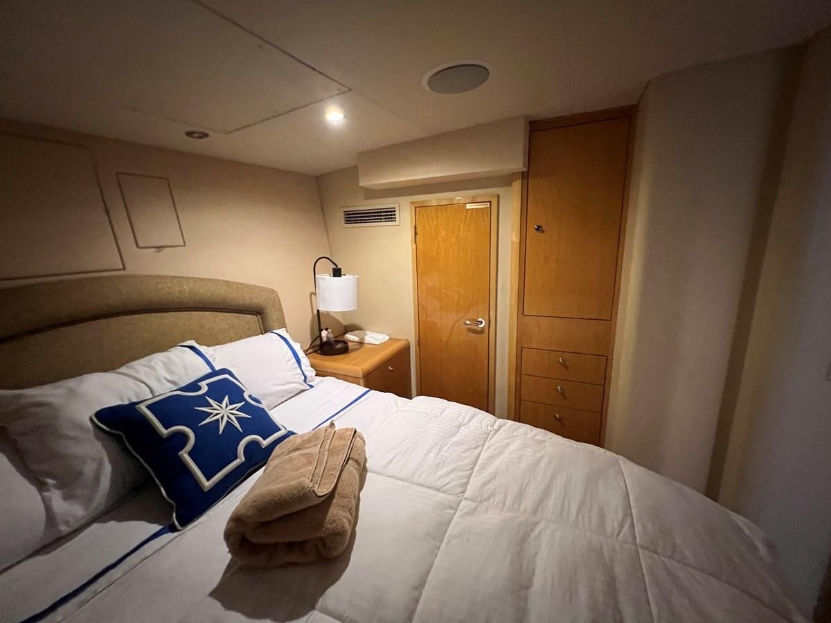 a bed with a white comforter and a pillow on it aboard ARETECTE Yacht for Sale