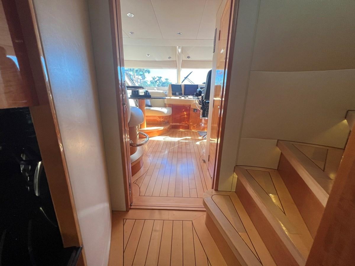 a room with a wood floor and a wood floor with a white wall aboard ARETECTE Yacht for Sale