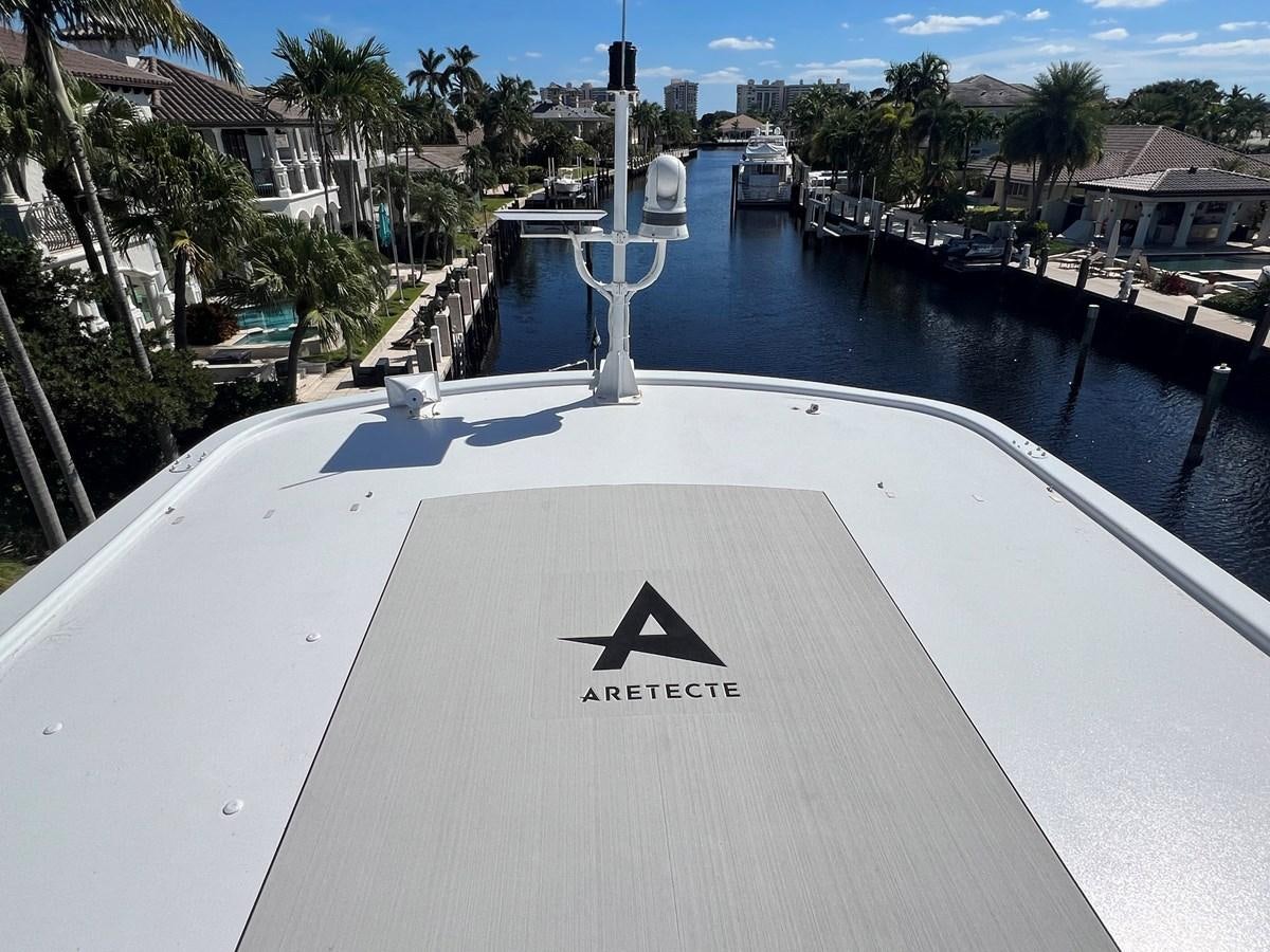 a white road with a cross on it and a body of water in the background aboard ARETECTE Yacht for Sale